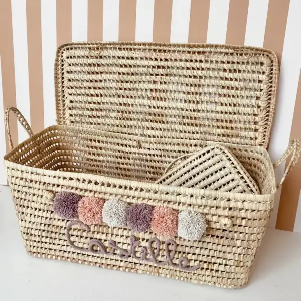 Personalized Moroccan Chest with Pompoms – Handwoven Palm Leaf Storage Trunk in Lilac, Vintage Pink & Beige