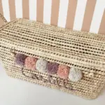 Personalized Moroccan Chest with Pompoms – Handwoven Palm Leaf Storage Trunk in Lilac, Vintage Pink & Beige