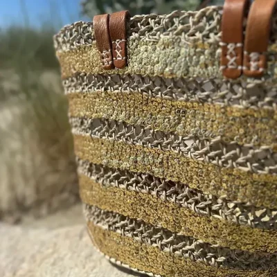ac2b831ce571b0dc6f498e0cadcb238620decc51163cb272c46a51554ce40be0-1.webp Sequin Basket – Handwoven Doum Palm Fiber Tote with Leather Handles & Drawstring Closure