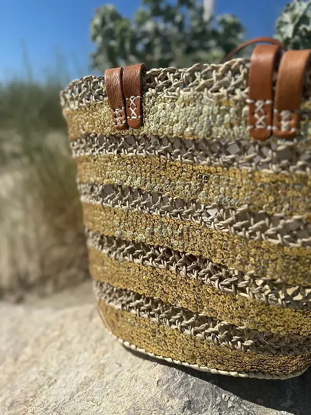 ac2b831ce571b0dc6f498e0cadcb238620decc51163cb272c46a51554ce40be0-1.webp Sequin Basket – Handwoven Doum Palm Fiber Tote with Leather Handles & Drawstring Closure