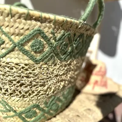 c53ecb917c3be1d5b8c7ec72add0216eb0aa0fe8af747cd38179e368a10063e4-2.webp Embroidered Palm Fiber Basket β Handwoven Moroccan Tote with Wool Embroidery