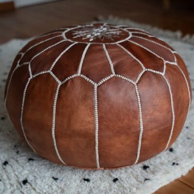 moroccan-leather-pouf-cognac-brown-on-rug.jpg Handcrafted Leather Pouffe – Cognac Brown Moroccan Ottoman