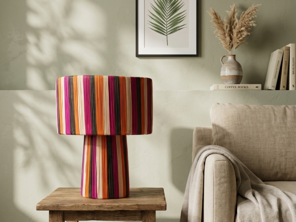 Handmade Moroccan raffia mushroom table lamp with bold multicolor striped weave in fuchsia, orange, black and natural, wide drum shade on pedestal base, eclectic boho decor