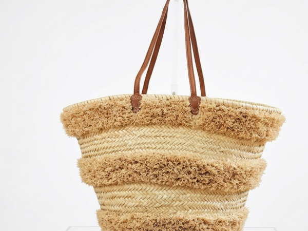 Handwoven Moroccan palm leaf straw basket bag with horizontal natural fringe stripe detail and genuine leather shoulder handles, large open-top boho beach market tote