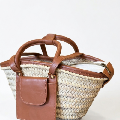 Moroccan Straw Basket Bag Leather Handles Convertible Tote Crossbody Handbag Palm Leaf Market Bag Pocket Boho Beach Bag Gift for Her (10) Close-up of Moroccan straw basket bag showing genuine leather front flap pocket, short top handles and long convertible crossbody strap