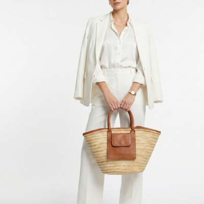 Moroccan Straw Basket Bag Leather Handles Convertible Tote Crossbody Handbag Palm Leaf Market Bag Pocket Boho Beach Bag Gift for Her (4) Woman carrying large handwoven Moroccan palm leaf straw basket tote with leather handles and front pocket, styled with linen blazer