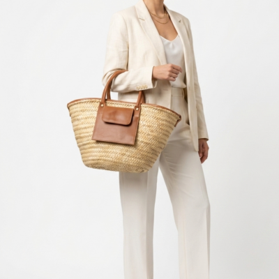 Moroccan Straw Basket Bag Leather Handles Convertible Tote Crossbody Handbag Palm Leaf Market Bag Pocket Boho Beach Bag Gift for Her (5) Woman carrying large handwoven Moroccan palm leaf straw basket tote with leather handles and front pocket, styled with linen blazer