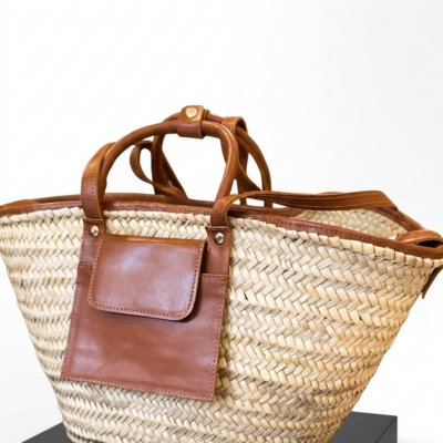 Moroccan Straw Basket Bag Leather Handles Convertible Tote Crossbody Handbag Palm Leaf Market Bag Pocket Boho Beach Bag Gift for Her (8) Close-up of Moroccan straw basket bag showing genuine leather front flap pocket, short top handles and long convertible crossbody strap