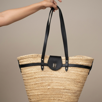 Handwoven Moroccan palm leaf straw shoulder bag with leather trim, long straps, front turn-lock pocket and silver hardware, boho market tote held by hand