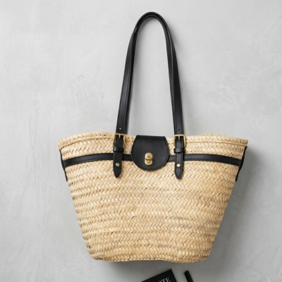 Handwoven Moroccan palm leaf straw shoulder bag with leather trim, long straps, front turn-lock pocket and silver hardware, boho market tote held by hand