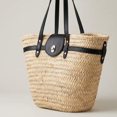 Handwoven Moroccan palm leaf straw shoulder bag with leather trim, long straps, front turn-lock pocket and silver hardware, boho market tote held by hand