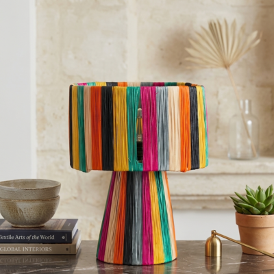 Handmade Moroccan multicolor raffia mushroom table lamp with bold rainbow stripes in teal, yellow, orange, fuchsia, black and grey, wide drum shade on tapered cone base