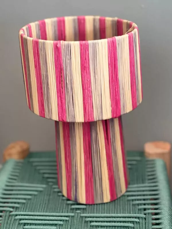 Handmade Moroccan raffia mushroom table lamp with pink grey and natural striped weave on solid square wood base, boho artisan desk light on terrazzo surface