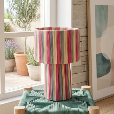Handmade Moroccan raffia mushroom table lamp with pink grey and natural striped weave on solid square wood base, boho artisan desk light on terrazzo surface