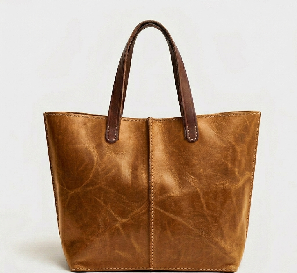 Handmade Moroccan pull-up distressed tobacco leather tote bag with two-tone tan body and dark espresso handles, center seam detail, open top, everyday work bag for women