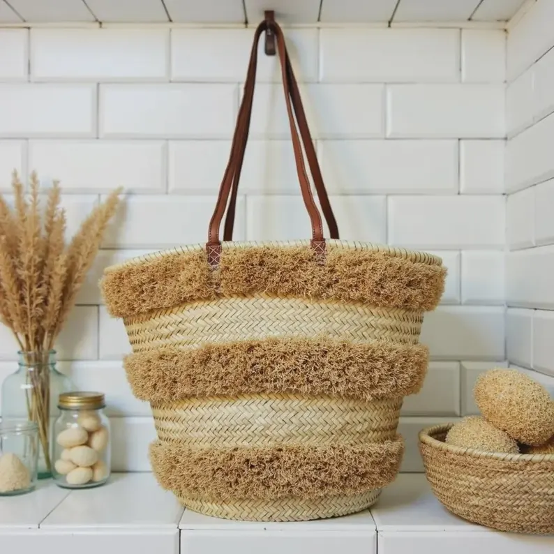 il_794xN.7687859269_icar Handwoven Moroccan palm leaf straw basket bag with horizontal natural fringe stripe detail and genuine leather shoulder handles, large open-top boho beach market tote